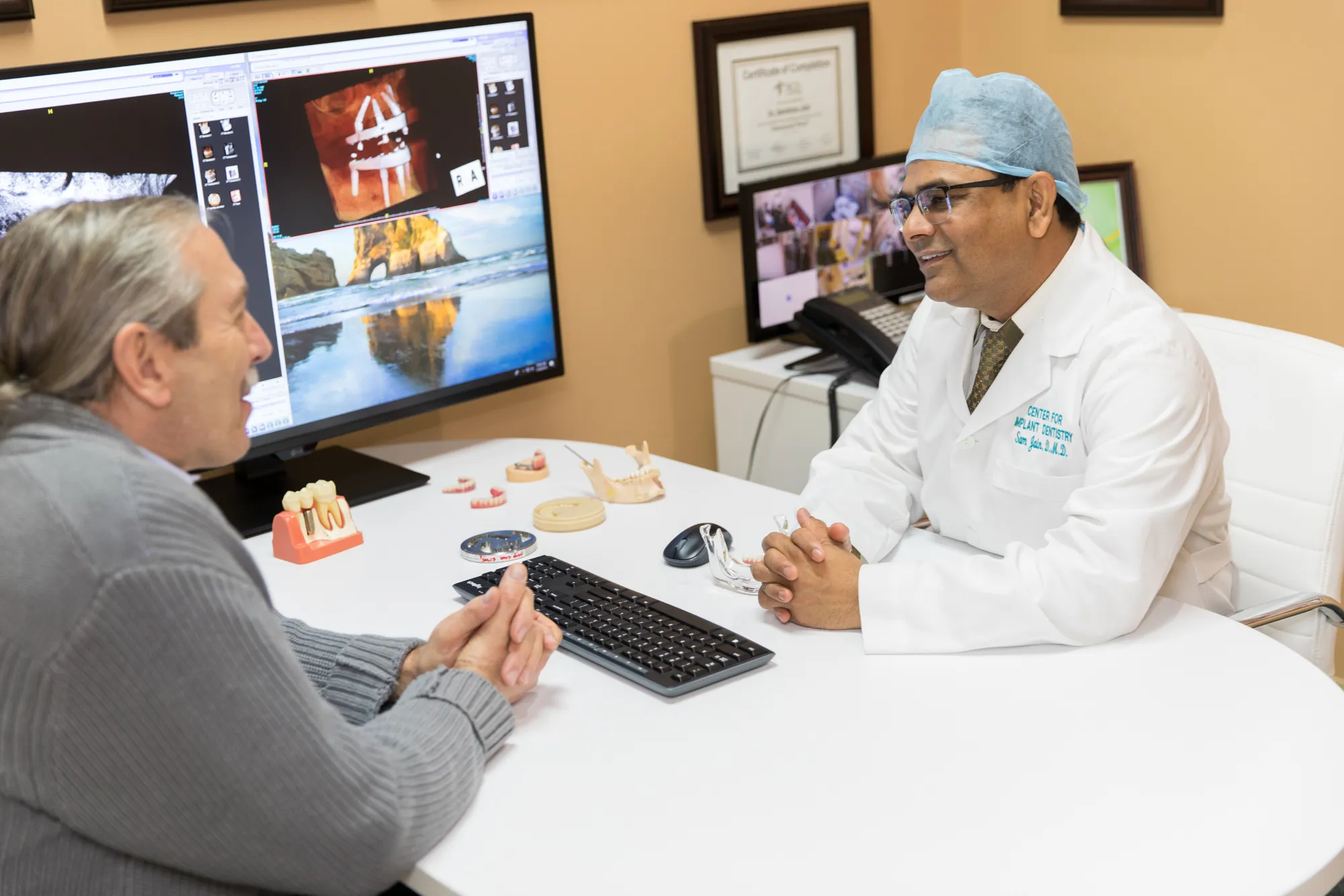 Dr. Sam Jain consulting with a patient about All-on-4 dental implants at Center for Implant Dentistry
